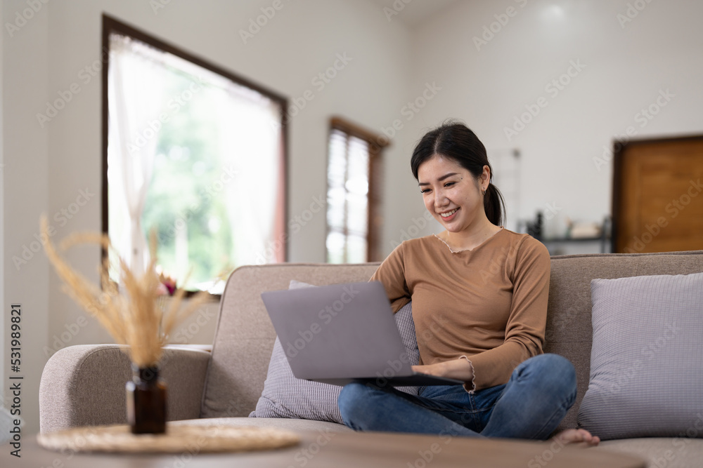 Young asian woman having conversation chatting while using laptop at house. Work at home, Video conference, Online meeting video call, Virtual meetings, Remote learning and E-learning Young asian woman having conversation chatting while using laptop at house. Work at home, Video conference, Online meeting video call, Virtual meetings, Remote learning and E-learning