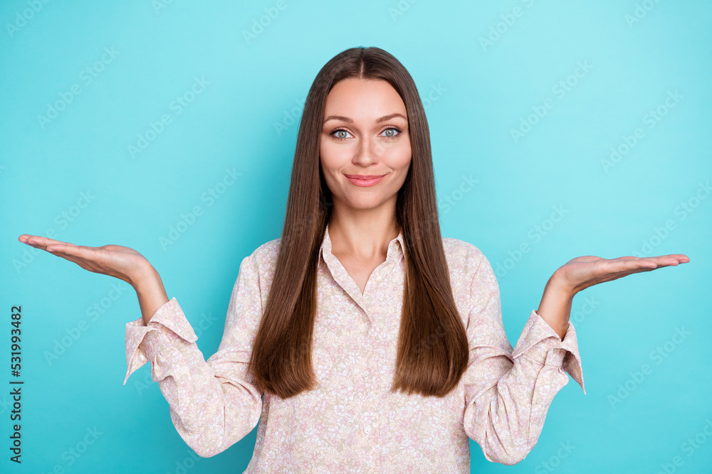 Photo of positive pretty stylish lady two arm compare decide trendy outfit clothes choose vs scales isolated on cyan color background Photo of positive pretty stylish lady two arm compare decide trendy outfit clothes choose vs scales isolated on cyan color background