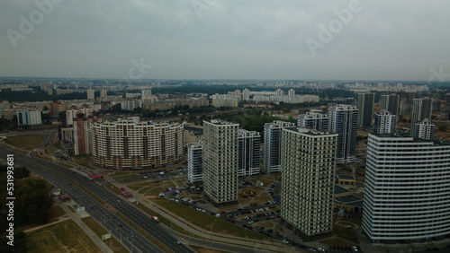 Construction site of a new city block. Construction of multi-storey buildings. Overcast weather. Aerial photography.