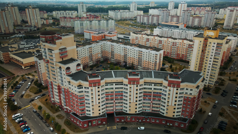 Fototapeta premium Modern urban architecture. Multi-storey buildings with infrastructure. Densely populated urban area. Overcast weather. Aerial photography.
