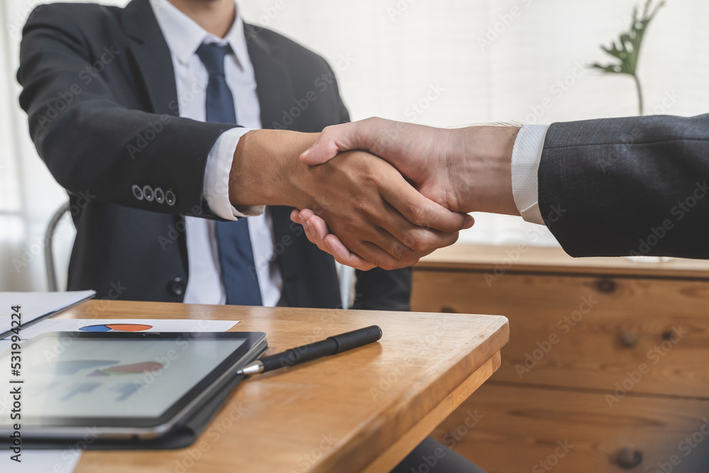 client and banker shaking hands on the meeting table after business investment budget done client and banker shaking hands on the meeting table after business investment budget done