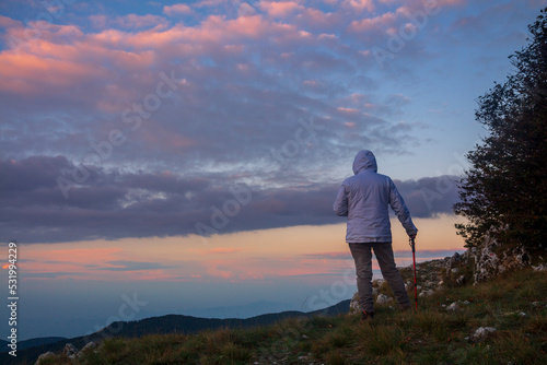 hiker on the mountain summit at sunrise in the Matese park