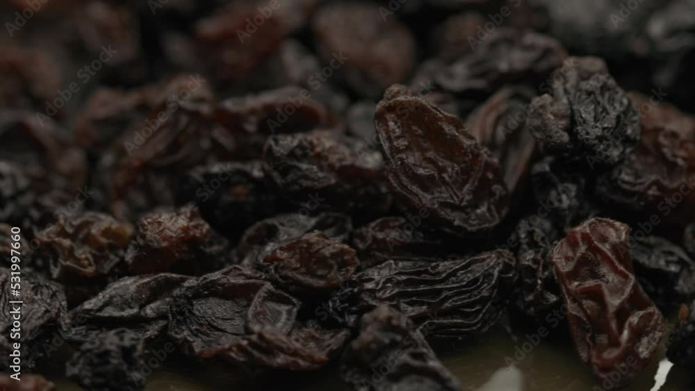 dark raisins rotate on a plate in a circle dark raisins rotate on a plate in a circle