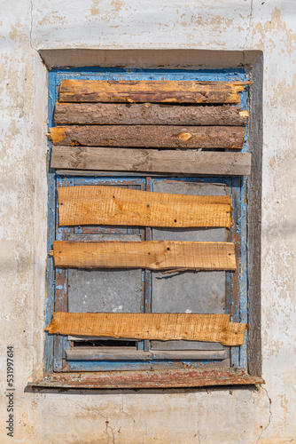 Boarded up window of an old building. Texture old wood board, boarded up house