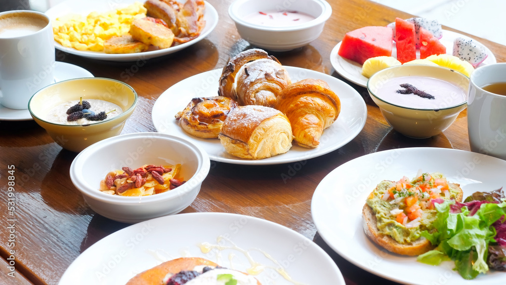 Wooden table full of various food in luxury restaurant, cafe breakfast Wooden table full of various food in luxury restaurant, cafe breakfast