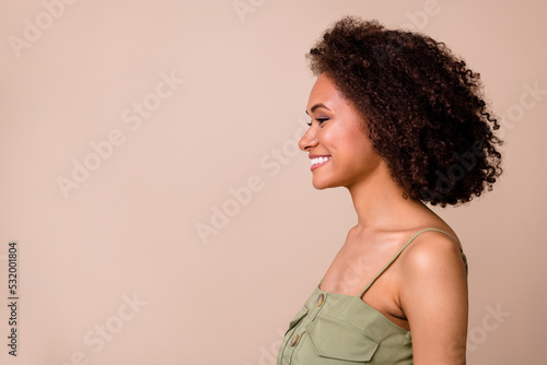 Profile photo of brunette funky millennial lady look empty space wear khaki top isolated on beige color background