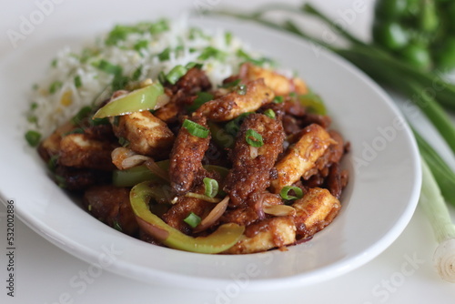 Panner Baby corn Manchurian. A crispy and crunchy Indo Chinese vegetarian dish, in a smooth gravy with stir fried capsicum and onions served along with fried rice