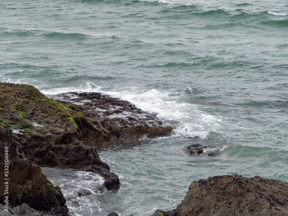 Wild rock beside of water. Ocean waves & Coastal Cliffs