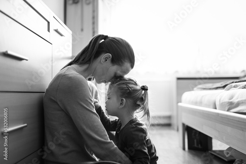 Portrait of mother taking care of child feeling tired stressed at home 