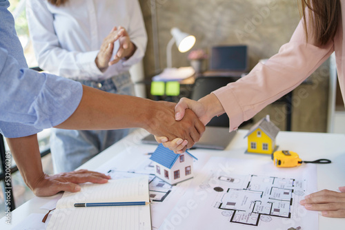 Architect and engineer work together and shaking hands to welcome home design projects to work in the same way and work together as a team.