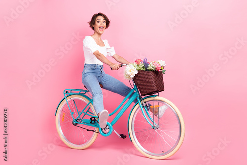 Fototapeta Naklejka Na Ścianę i Meble -  Full length photo of excited funky lady wear white crop top riding bike fast isolated pink color background