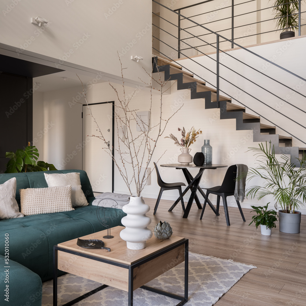 Dining table under stairs in open living room Stock 写真 Adobe Stock