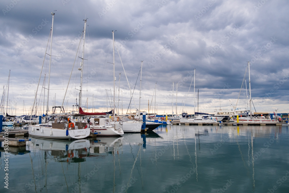 Calm evening in a harbour with sailing boats