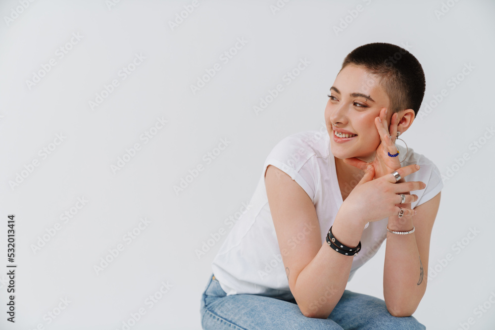 Young european woman with short hair smiling and looking aside Young european woman with short hair smiling and looking aside