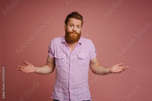 Ginger white man with beard looking and gesturing at camera