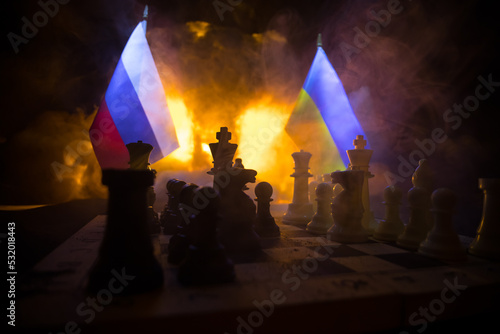 Chess board game concept of business ideas and competition and strategy ideas concep. Chess figures on a dark background with smoke and fog. Selective focus