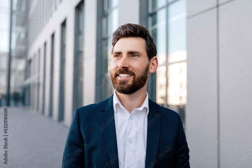 Successful business in city. Portrait of happy inspired confident attractive young caucasian man with beard Successful business in city. Portrait of happy inspired confident attractive young caucasian man with beard