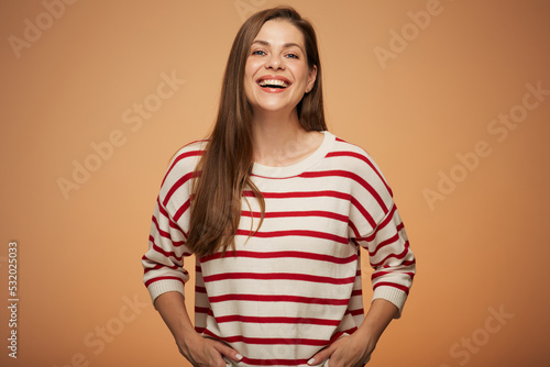 Smiling woman in casual clothes with hands in pockets. Isolated female portrait.