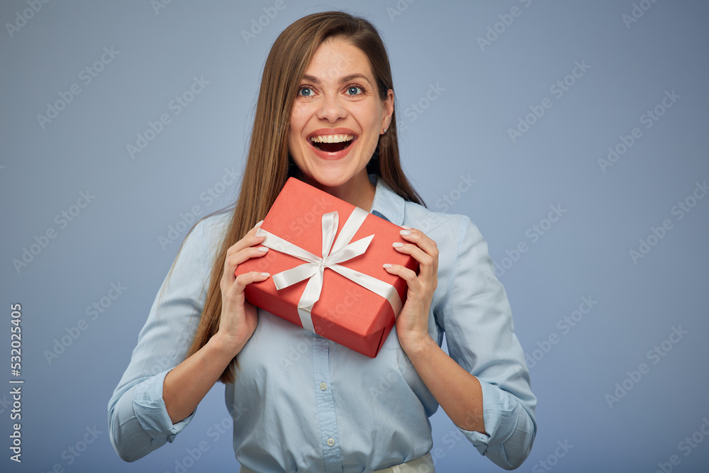 Young smiling woman holding red gift box. Isolated female portrait. Young smiling woman holding red gift box. Isolated female portrait.