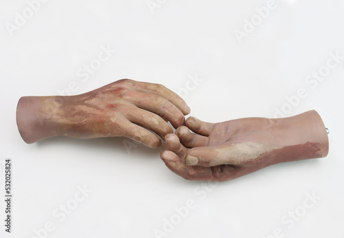 Hands of plastic mannequin on white background.