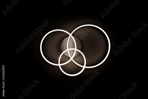 Chandelier luminous in the form of three rings against a black ceiling