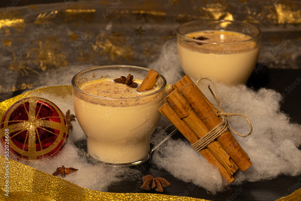 two cups of eggnog with nutmeg nutmeg cinnamon stick and anise seeds ...