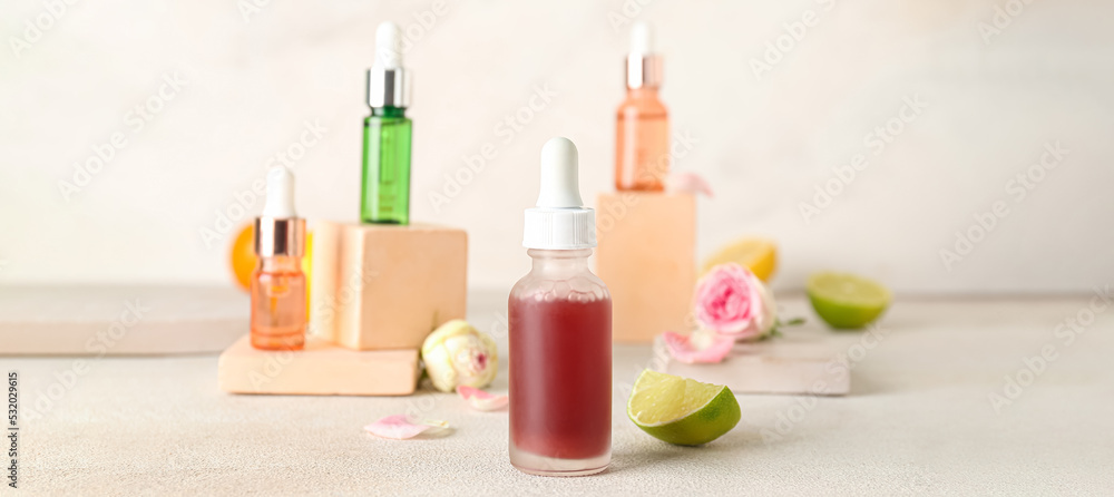 Bottles of citrus essential oil on light table