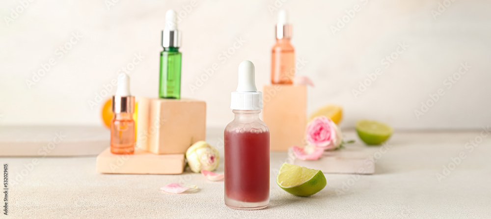 Bottles of citrus essential oil on light table Bottles of citrus essential oil on light table
