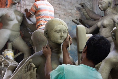 Clay idol of Goddess Durga, under preparation for Bengal's Durga Puja festival at Kumartuli Kolkata. photo