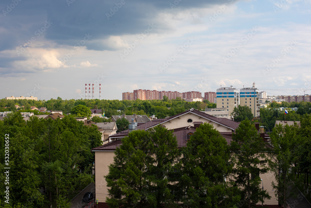 View of the city of Vidnoye, Moscow region Russia from the Ferris wheel in the city park. Shkolnaya street and administrative building shrouded in greenery.