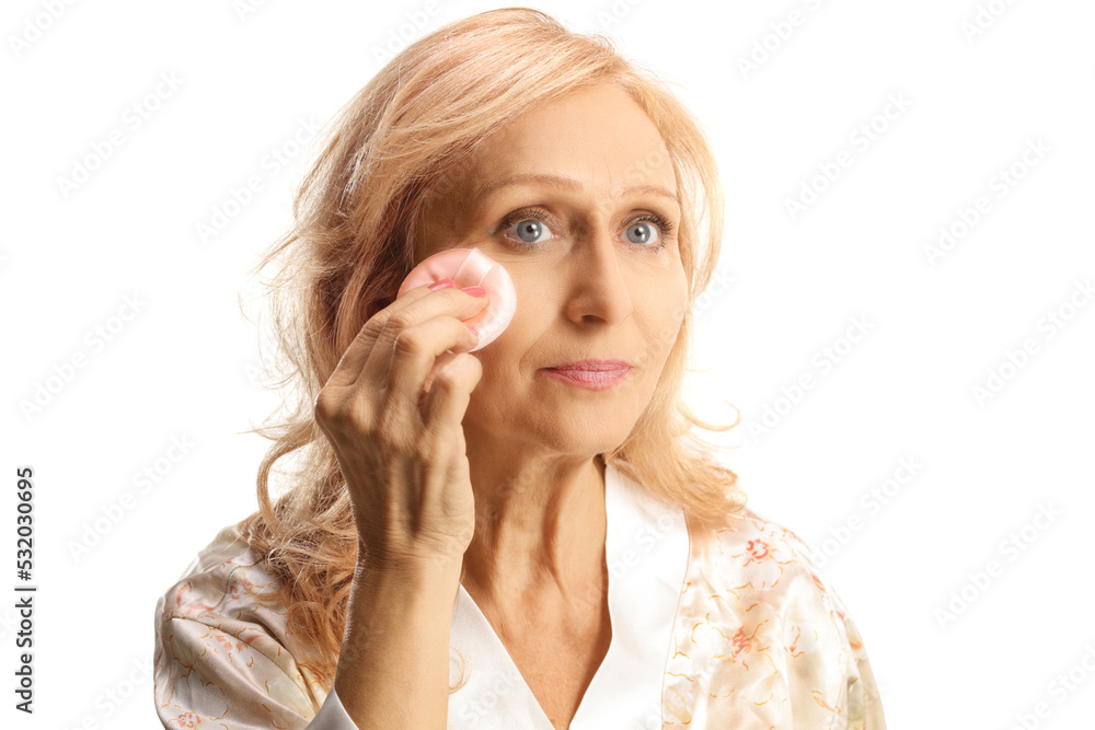 Mature woman removing make up with a cotton pad Mature woman removing make up with a cotton pad
