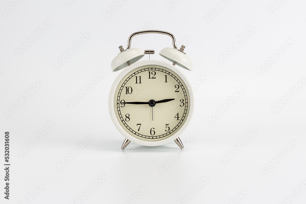 White retro clock alarm clock on white background shows 02:45 am or 02:45 pm or 14:45 White retro clock alarm clock on white background shows 02:45 am or 02:45 pm or 14:45