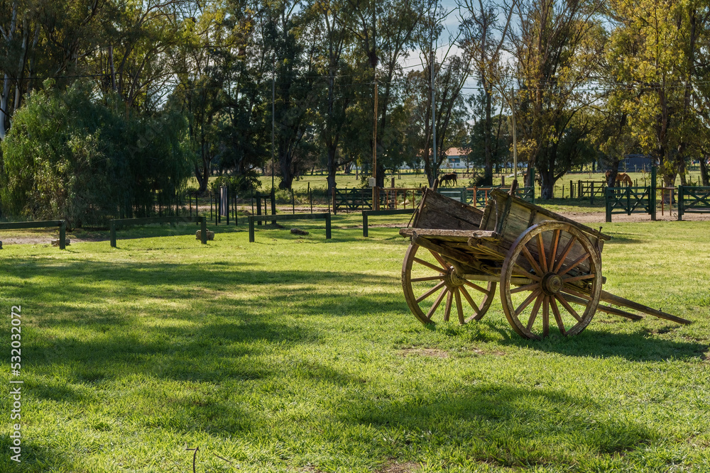 Old wooden cart used as decoration in a field. copy-space