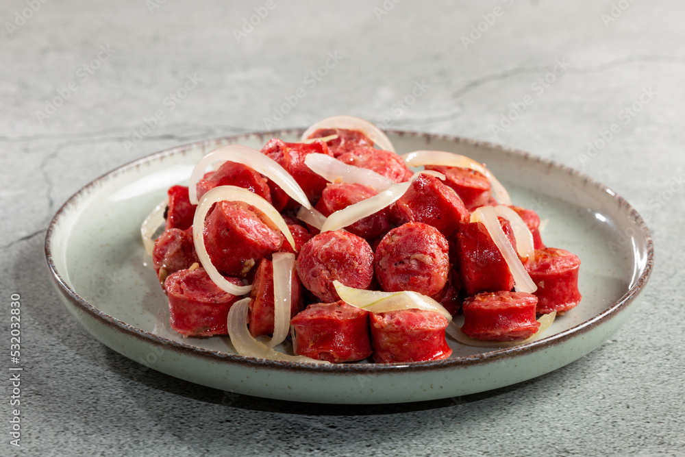 Portion of sausage with onion. Portion of sausage with onion.