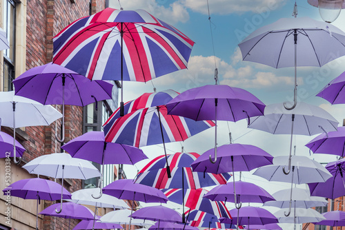 Street adorned with umbrellas with the flag of the United Kingdom.