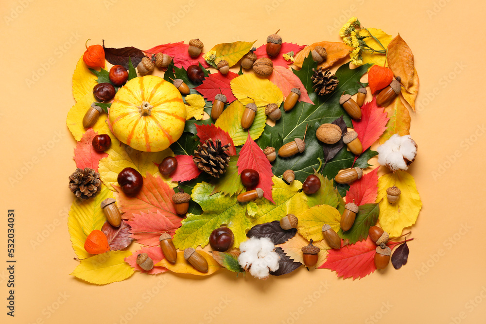 Naklejka premium Autumn forest decor, cotton flowers and pumpkin on color background