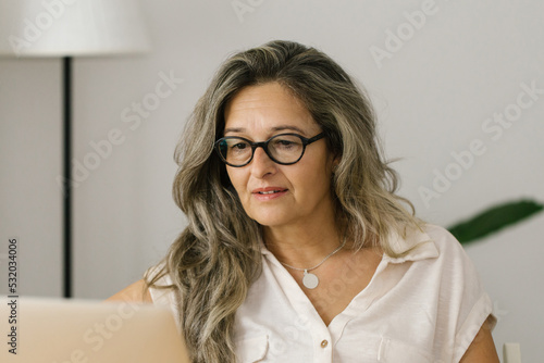 Portrait of adult woman working from home, businesswoman working at home office 