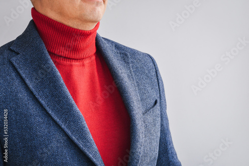 Classic tweed men's jacket with red sweater. Fashion and lifestyle. Portrait of a buisinessman in a jacket.  photo