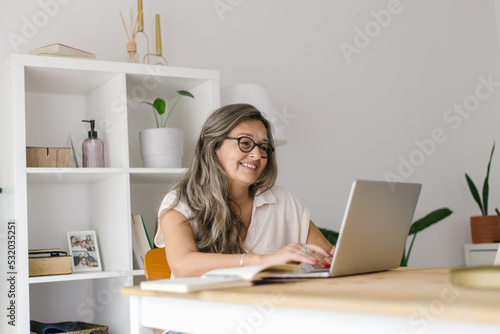 Adult woman working from home using laptop 