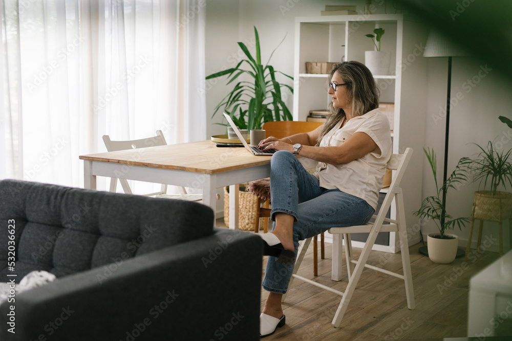 Caucasian woman working remote from home via laptop. Caucasian woman working remote from home via laptop.