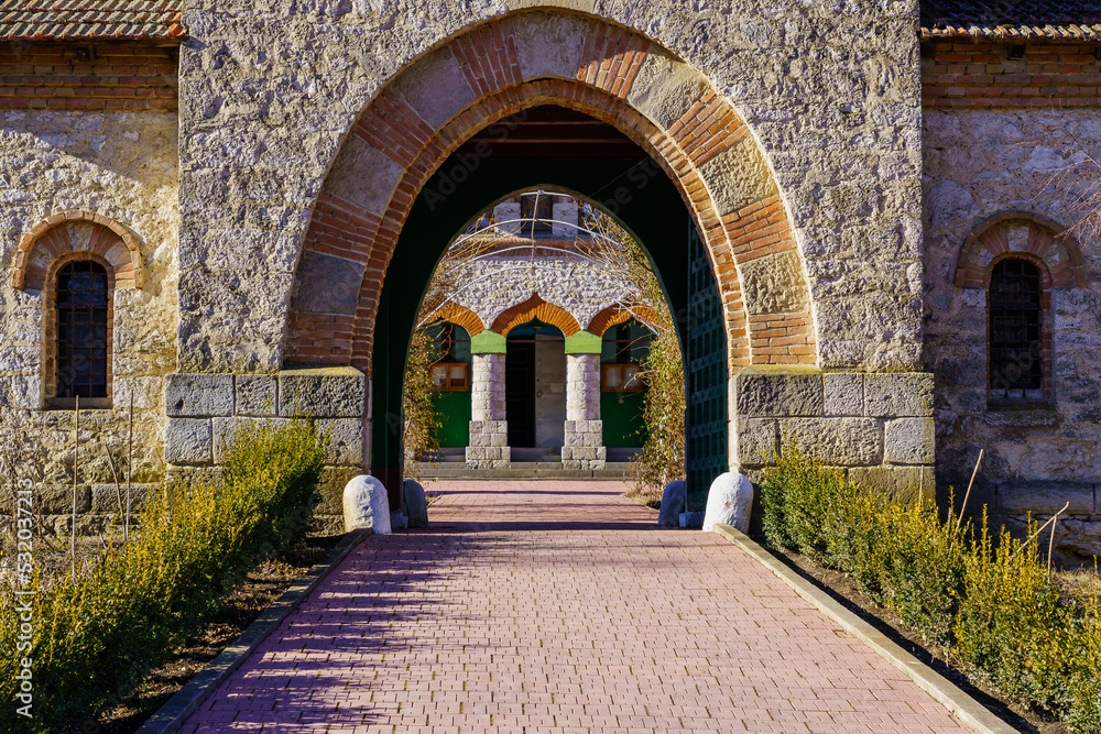 Stone arch at the entrance to the old stone church. Background with selective focus and copy space