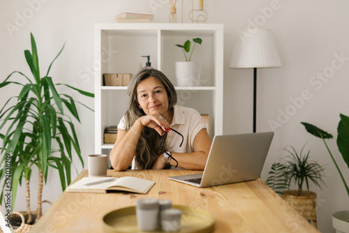 Female freelancer sitting and looking at the camera