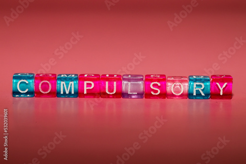 the word "compulsory" made up of cubes