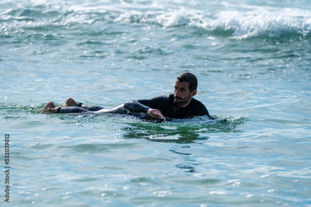 Surfer rowing over the water