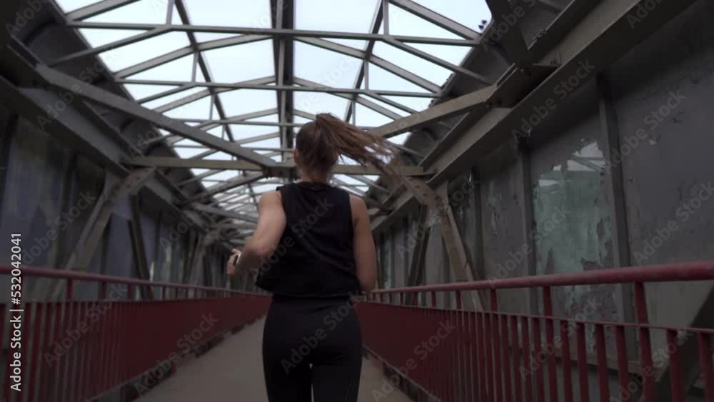 The back view of the woman running in a city The back view of the woman running in a city