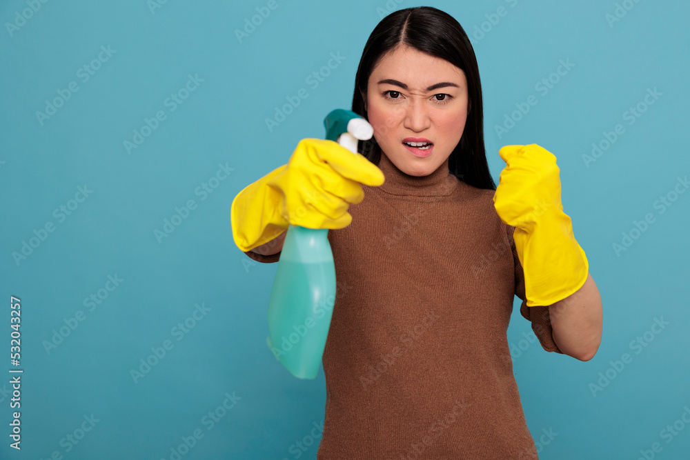 Angry frustrated asian young housewife in rubber gloves and detergent spray standing in a fight pose, Cleaning home concept, Aggressive energetic housekeeper feeling negative Angry frustrated asian young housewife in rubber gloves and detergent spray standing in a fight pose, Cleaning home concept, Aggressive energetic housekeeper feeling negative