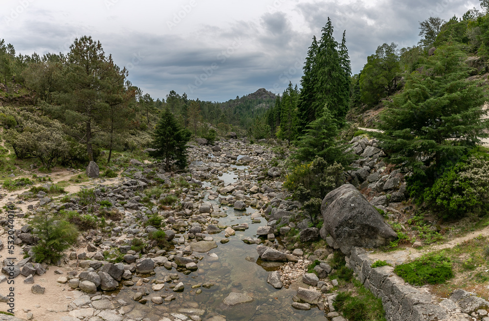 Obraz premium Peneda-Gerês National Park is located in northern Portugal. Its rugged hills are home to deer, wolves and golden eagles. The trails include a Roman road lined with landmarks.