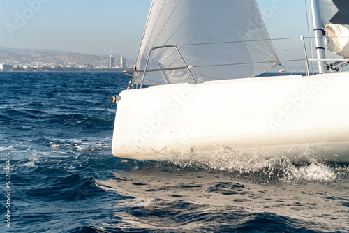 Side view close-up of a bow of a sport yacht in the open sea © kirill_makarov