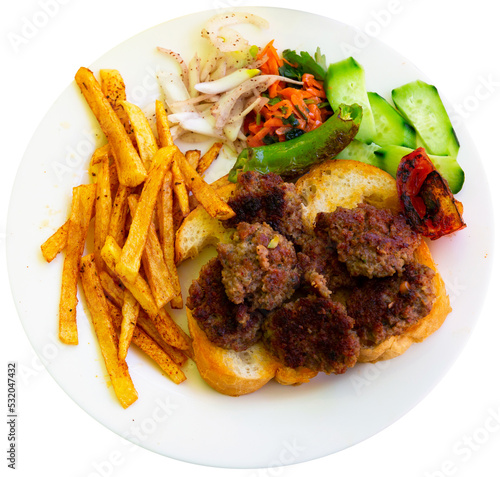 Fototapeta Spicy kofte (grilled minced meat) served with fresh cucumber, bread, vegetables