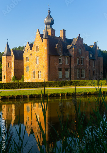 Reflection of Rumbeke Castle in water on summer day located in Rumbeke in West Flanders, Belgium photo